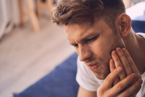 man with dental pain looking for What Are The Top Homeopathic Remedies For Dental Pain