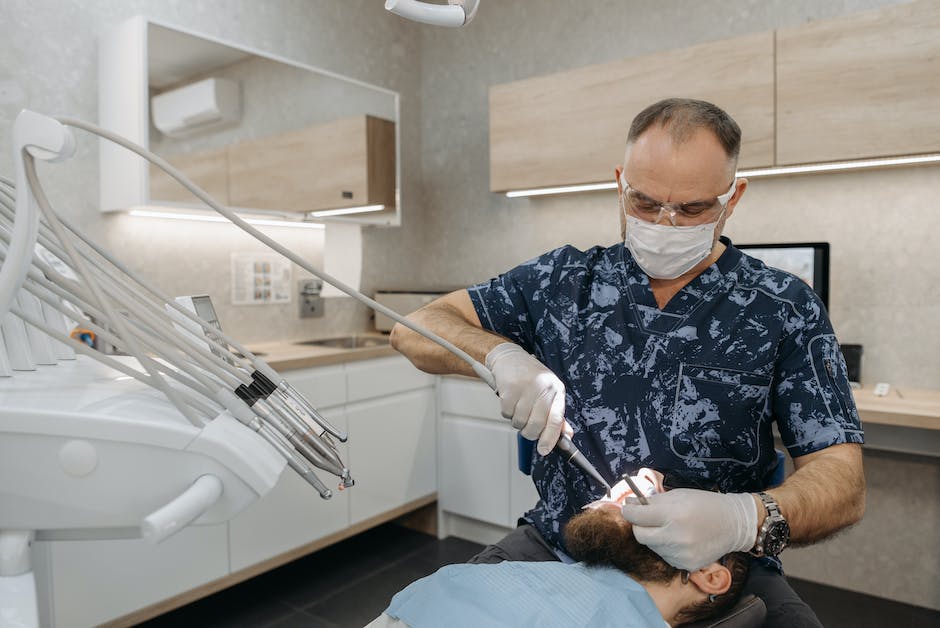 Image of a dental checkup with a dentist examining a patient's teeth