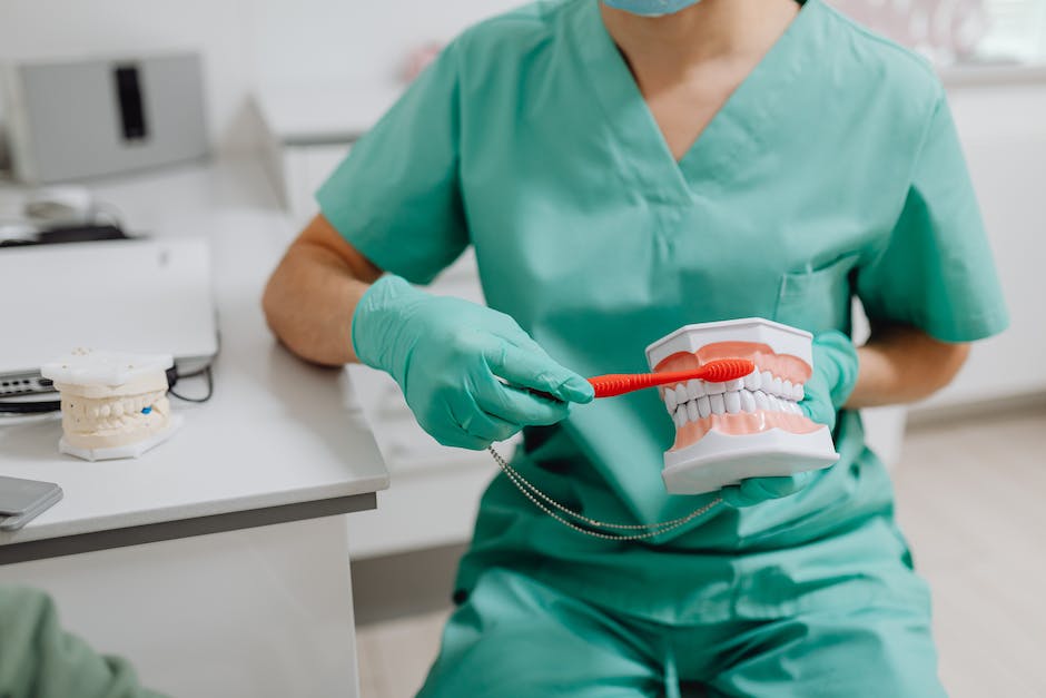 An image showing a person brushing their teeth.